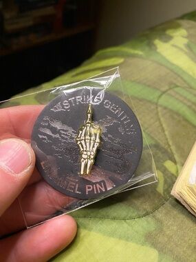 Brand New In Package Strike Gently Skeleton Flipping Bird Enamel Pin